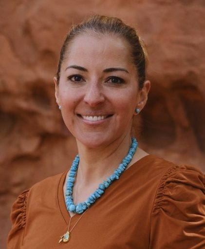 Olivia Sloan, smiling with red rocks in the background